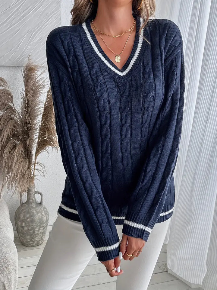 Chic women's navy V-neck cable knit sweater with striped trim, cozy long sleeve for preppy fall & winter casual wear.