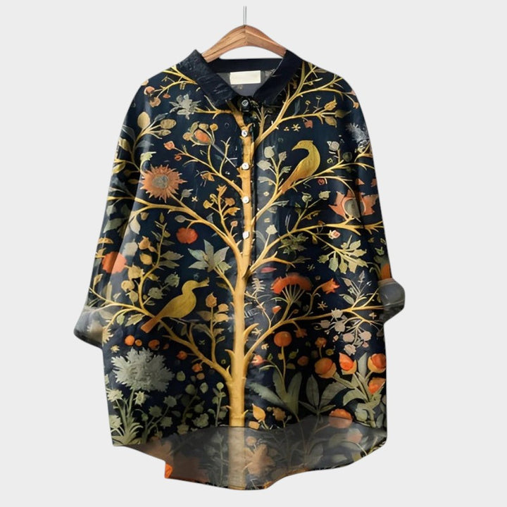 Boutique women's blouse with delicate nature-inspired artistic prints, a stylish and comfortable long sleeve top.