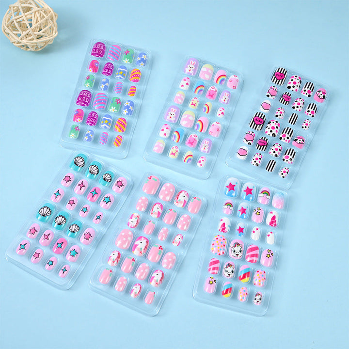 Women's ocean themed press-on nails with shimmering blue and white seashell designs for summer beach style.