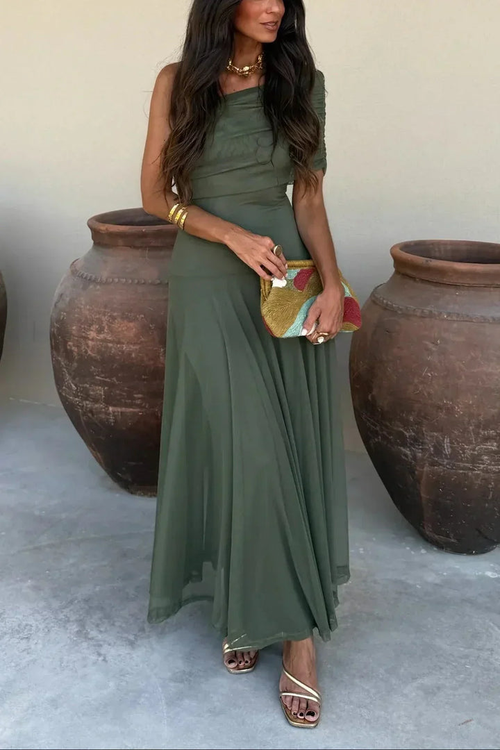 Stylish women's off-shoulder formal maxi dress with a draped waist, suitable for wedding guests.
