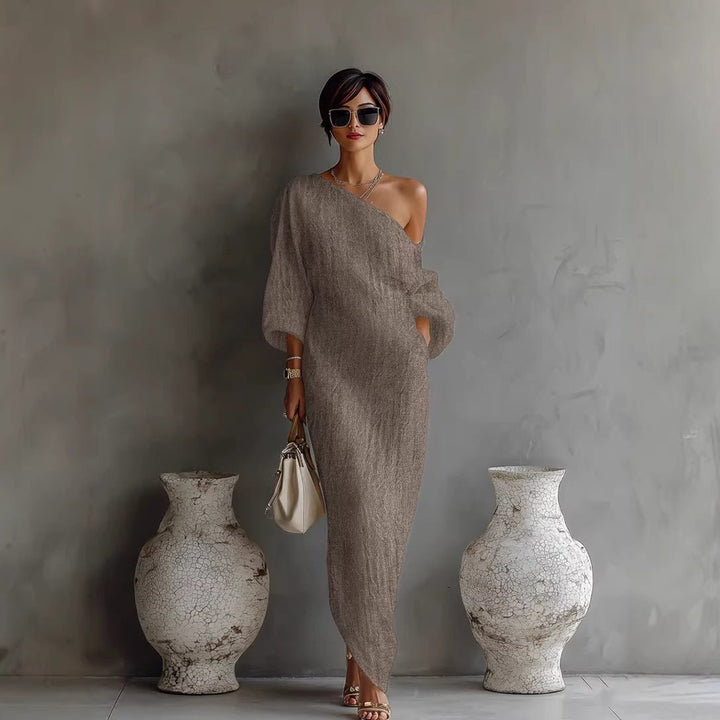 Long, flowing off-shoulder maxi dress for women, with chic lantern sleeves & loose fit, embodying minimalist fashion.