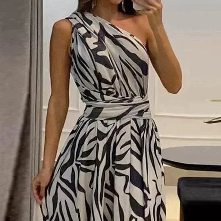 Elegant blue printed one-shoulder maxi dress. Comfortable vacation or party wear, an effortless women's statement piece.