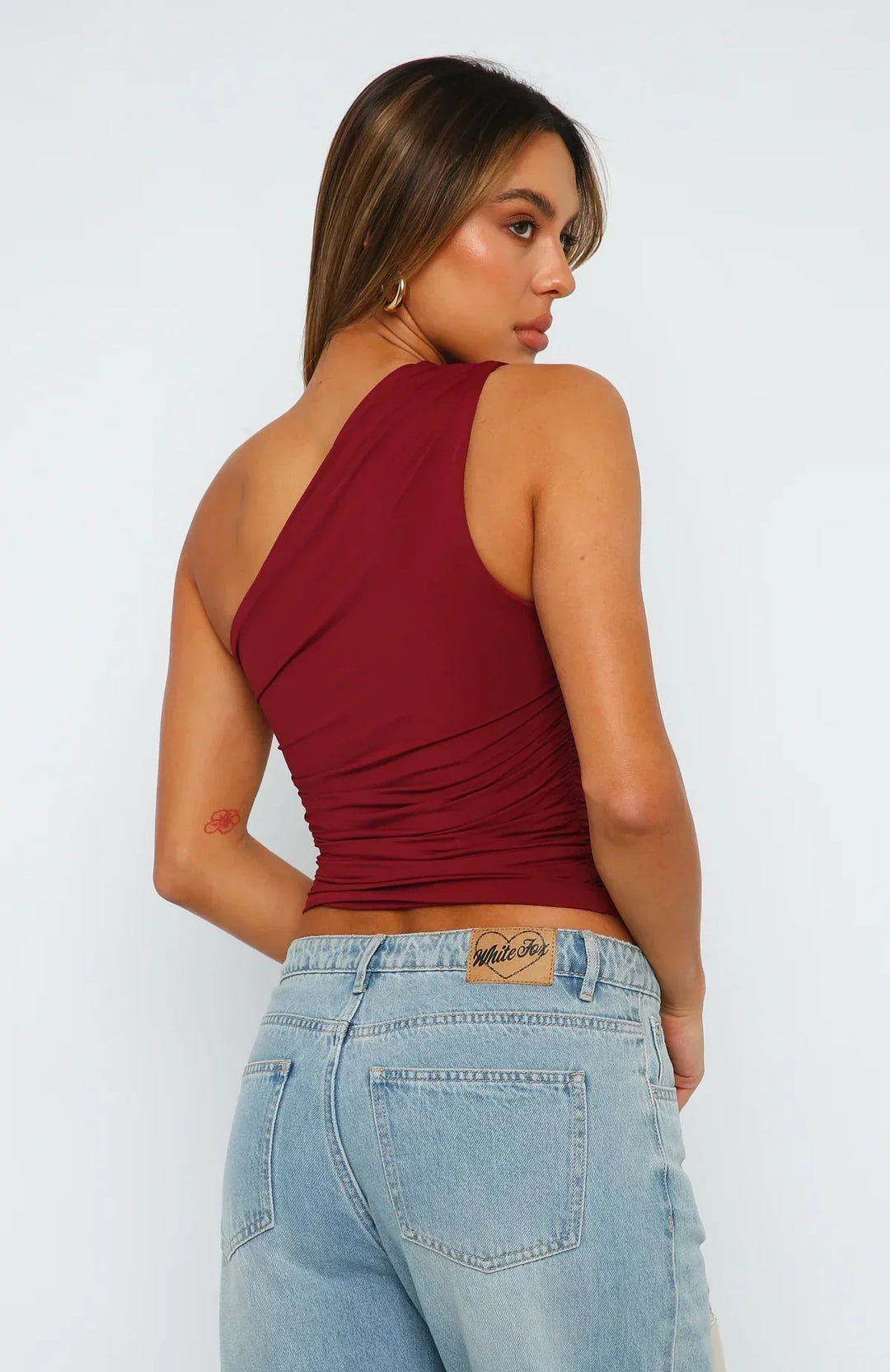 Trendy asymmetric women's crop top with ruched detailing, ideal for evening & date nights.