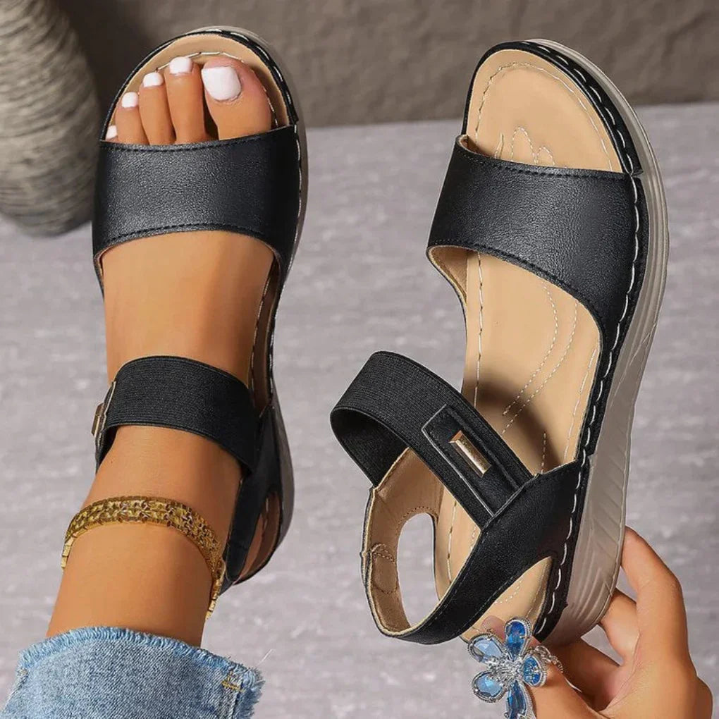 Women's open toe comfort sandals with cushioned sole, perfect for summer casual wear. Adjustable slip-on flats.