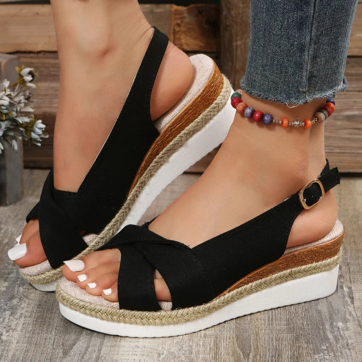 Stylish open-toe women's wedge sandals with comfortable ankle strap, perfect for summer.