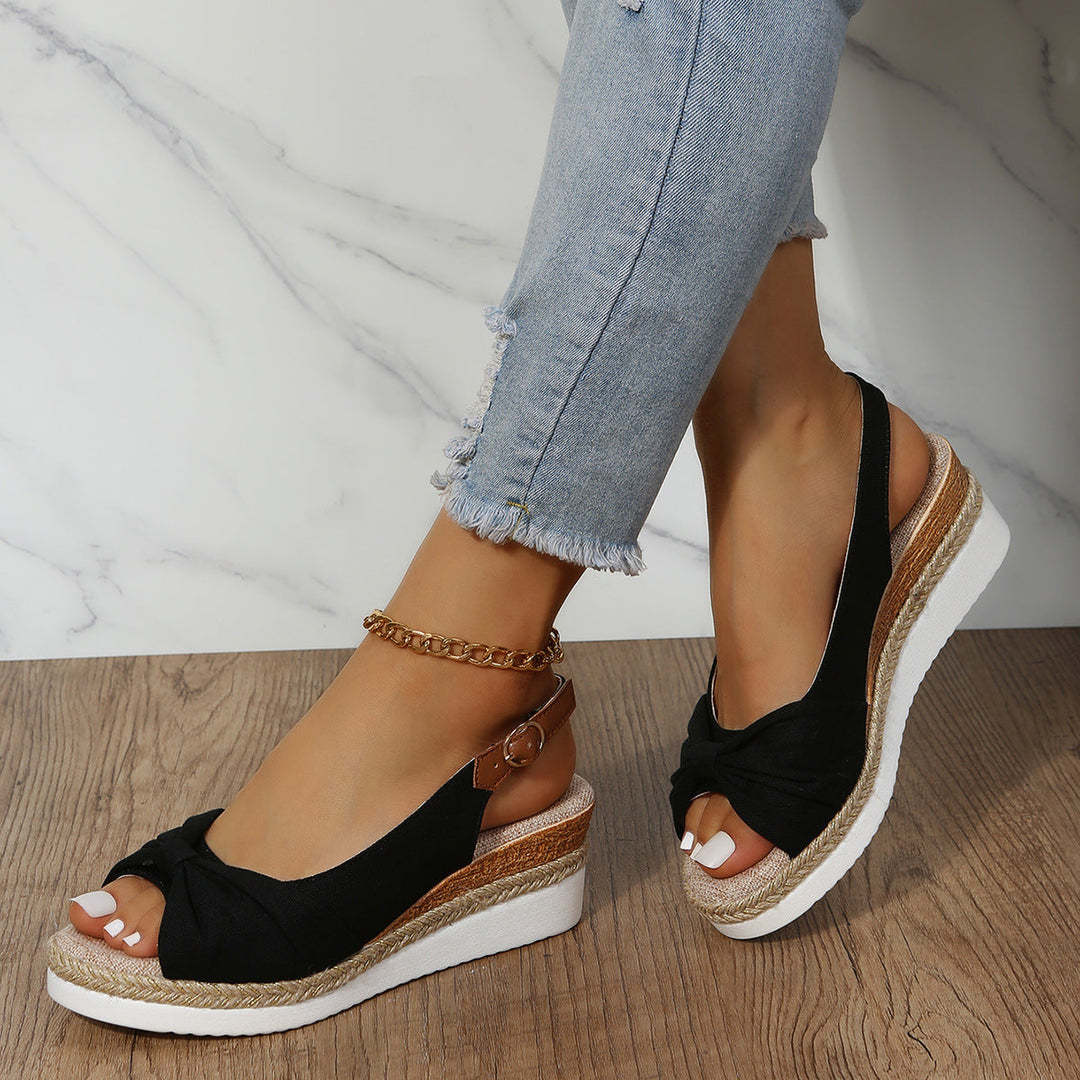 Elegant women's open-toe wedge sandals, comfortable design with secure ankle strap for summer.
