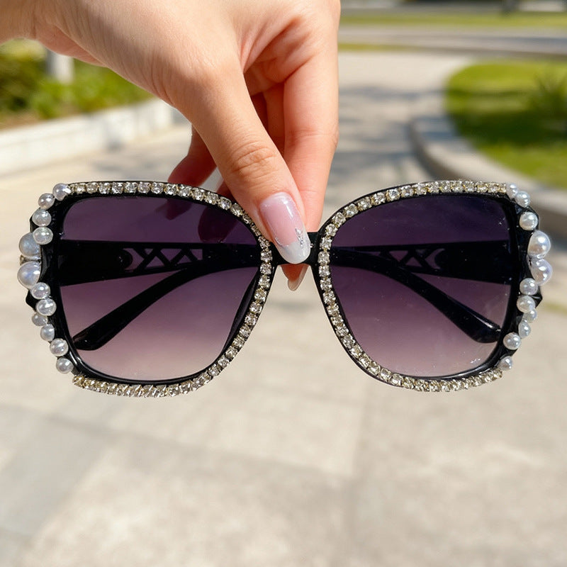 Women's ornate cat-eye sunglasses with crystal embellishments, offering glamorous retro style & UV protection.