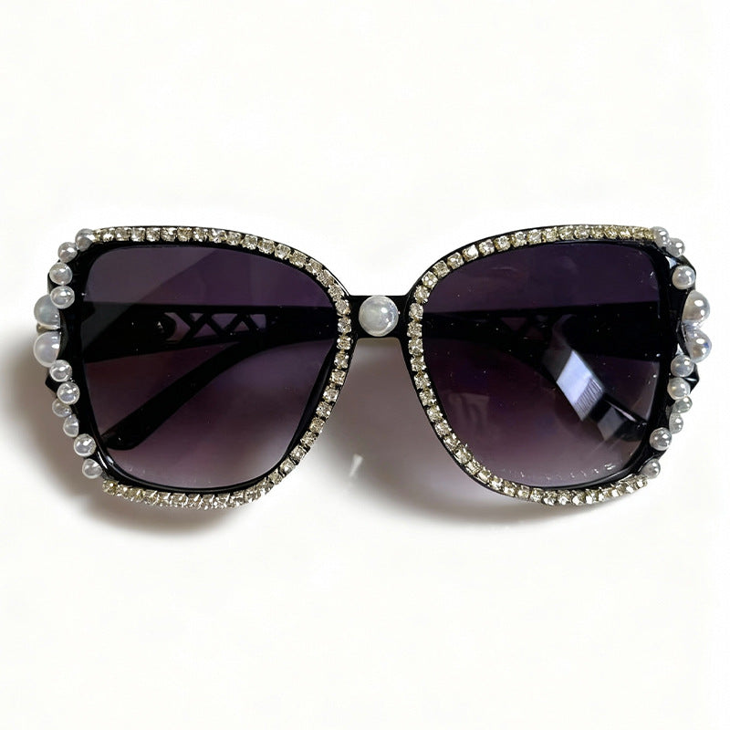 Women's embellished cat-eye sunglasses, adorned with sparkling crystals for a luxurious & retro fashion look.