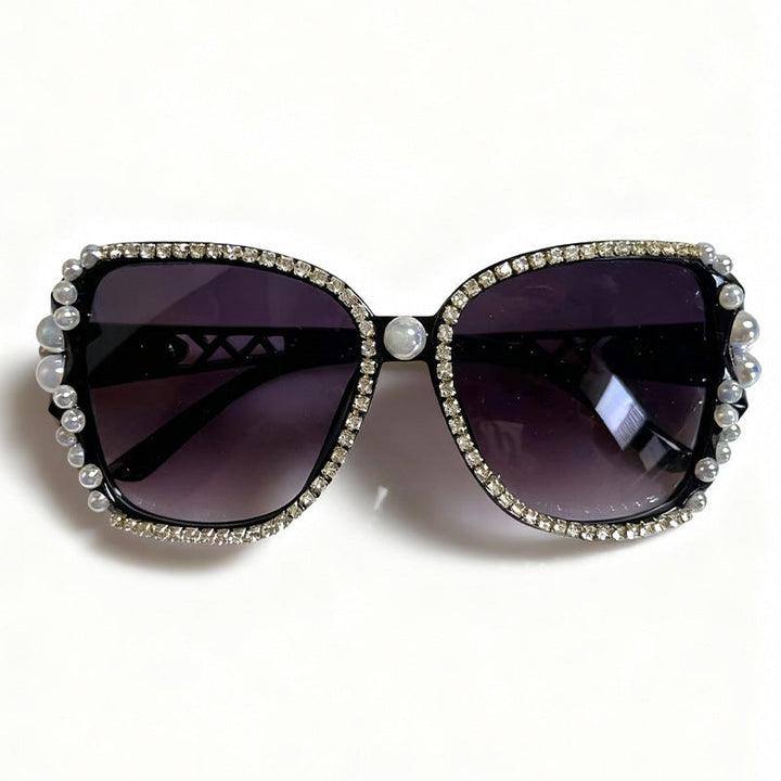 Women's embellished cat-eye sunglasses, adorned with sparkling crystals for a luxurious & retro fashion look.