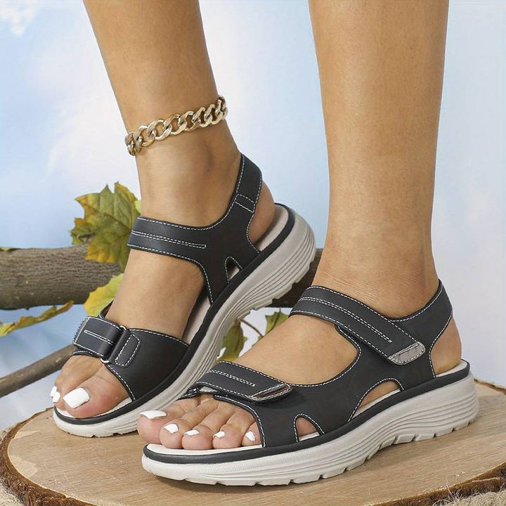 Stylish women's orthopaedic sandals with adjustable straps, providing comfort & arch support for daily wear.