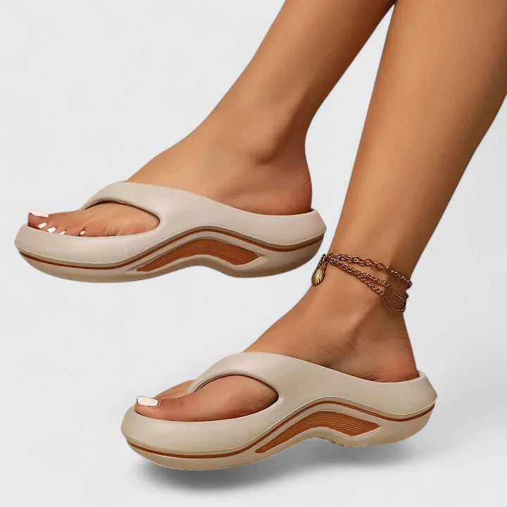 Lightweight women's orthopaedic slides with arch support, designed for ultimate foot comfort.