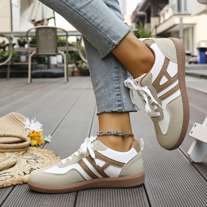 Close-up of women's orthopedic comfort sneakers, showcasing breathable upper and supportive sole for arch relief.