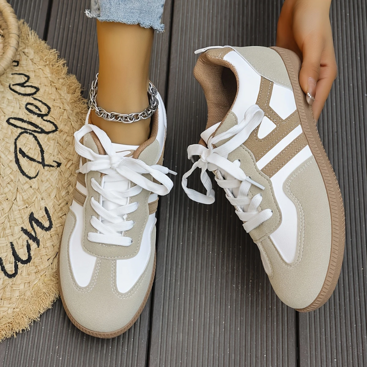 Woman wearing comfortable orthopedic walking sneakers outdoors, demonstrating flexible design & arch support.