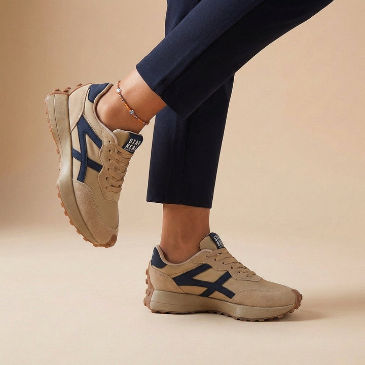 Sporty women's orthopedic walking shoes with stylish contrast panels and secure lace-up closure for comfort.