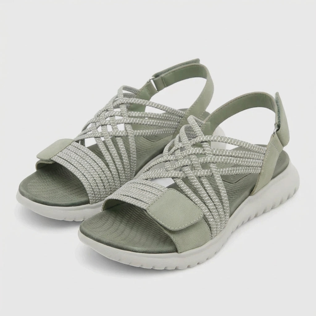 Supportive women's flat sandals with criss-cross design, offering everyday orthopedic comfort.