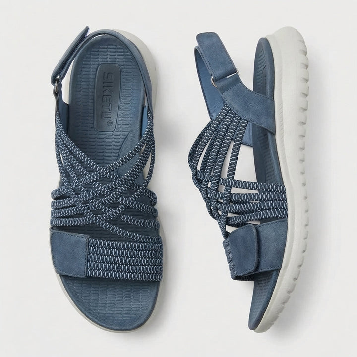 Fashionable orthopedic sandals for women, featuring a criss-cross strap for ultimate comfort & travel.