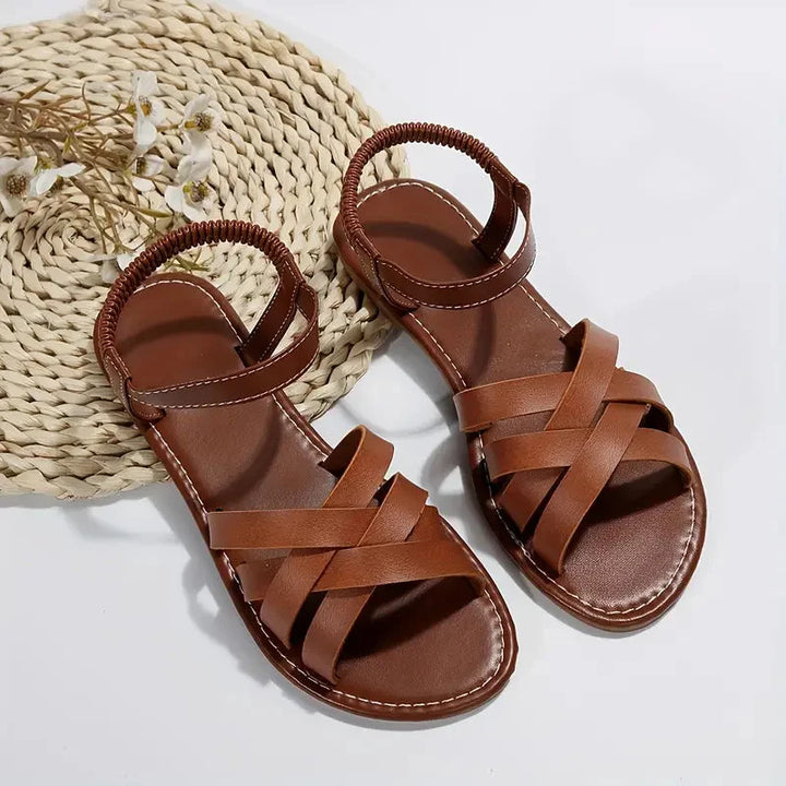 Versatile women's comfort sandals, orthopedic design with criss-cross straps & adjustable fit for daily wear.