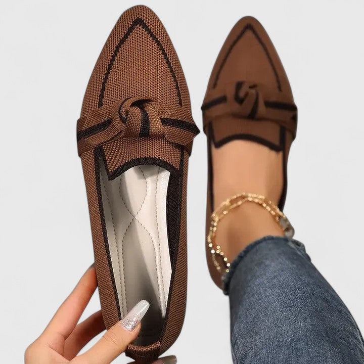 Black slip-on women's flats with orthopedic arch support, perfect for casual or dressy occasions.