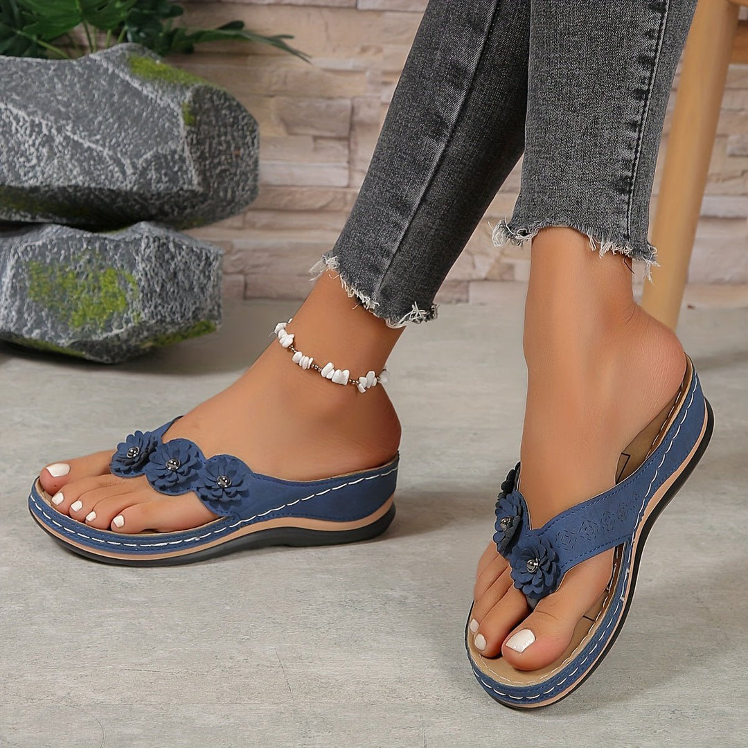 Elegant women's orthopedic sandals, slip-on style, flower accents, arch support & comfortable wedge.