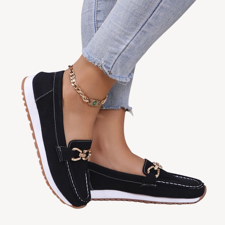 Women's orthopedic loafers with elegant chain detail for comfortable daily wear. Supportive slip-on fashion.