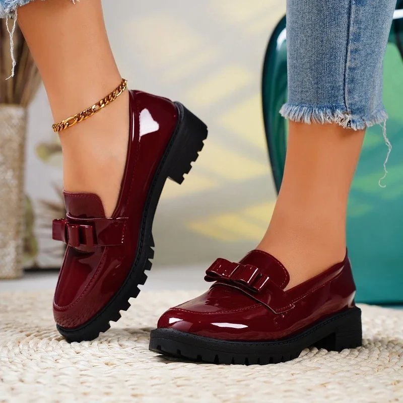 Women's orthopedic patent leather loafers with elegant bow detail. Comfort slip-on shoes for casual & smart fashion.