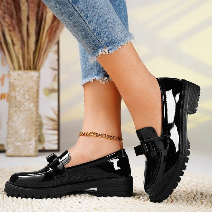 Smart casual women's patent leather slip-on loafers. Orthopedic comfort shoes with an elegant bow detail.