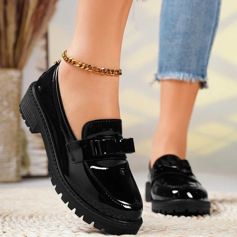 Chic women's orthopedic patent leather loafers. Slip-on comfort shoes with a distinctive bow & durable chunky sole.