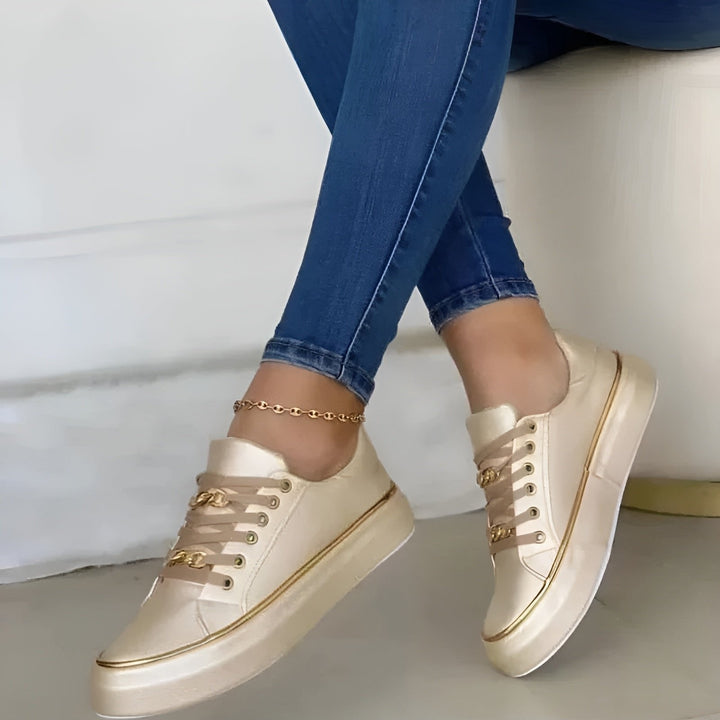 Chic women's orthopedic platform trainers. Gold-accent lace-up fashion sneakers providing both style and support.