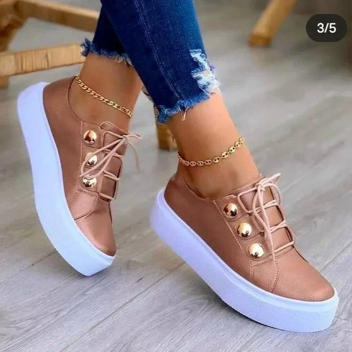 Comfortable women's orthopedic trainers, platform style, providing foot support for everyday wear. Features gold studs.
