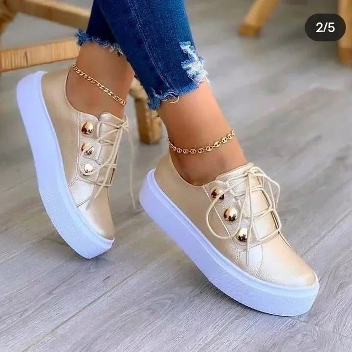 Studded platform trainers for women. Lace-up orthopedic sneakers with gold studs and a stylish chunky sole.