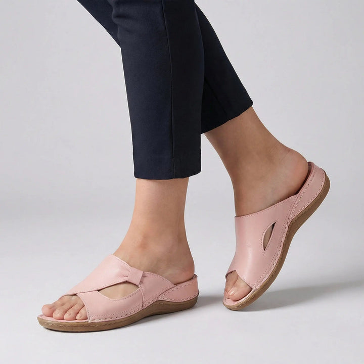 Orthopedic women's open-toe slides offering arch support and comfortable everyday wear with trendy cutouts.