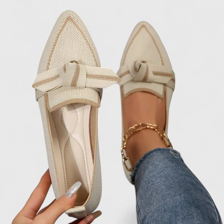 Side view of women's orthopedic slip-on loafers with chic bow. Elegant, comfortable flats for stylish everyday fashion.