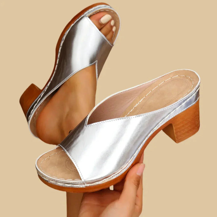 Supportive women's orthopedic mule sandals. Arch support, block heel, slip-on comfort for everyday wear.
