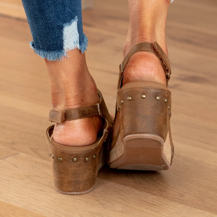 Close-up: Sole of women's orthopedic wedge sandals. Features arch support & comfortable platform for daily wear.