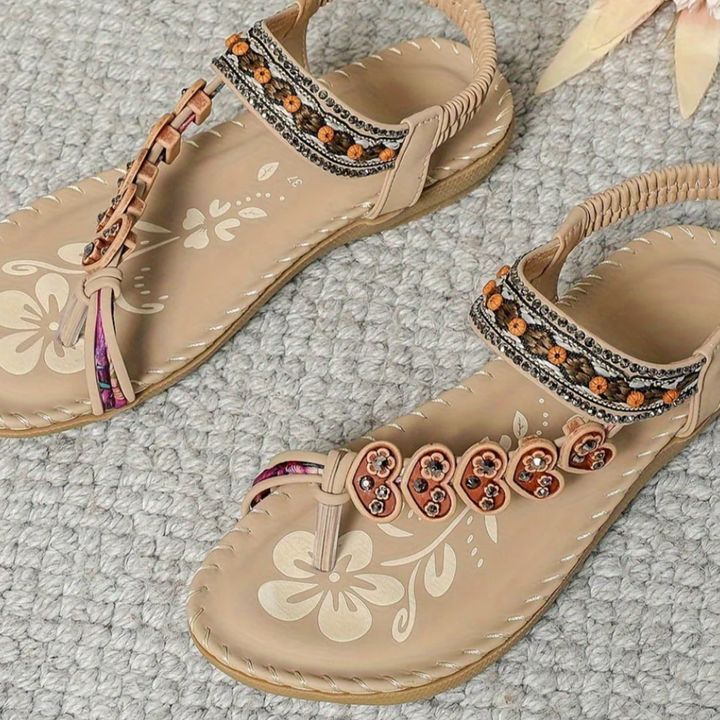 Comfortable women's T-strap flat sandals, orthopedic design with arch support for foot health.