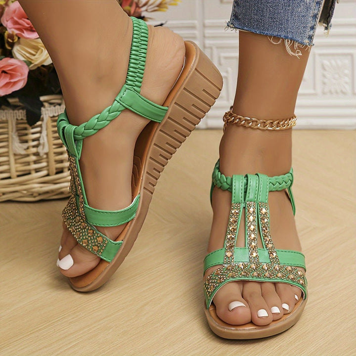 Embellished women's T-strap wedge sandals with metallic details and orthopedic comfort.