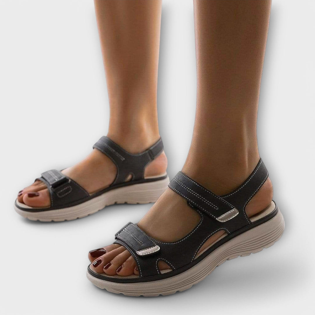 Women's orthopedic walking sandals with arch support & adjustable straps for comfort & foot pain relief.