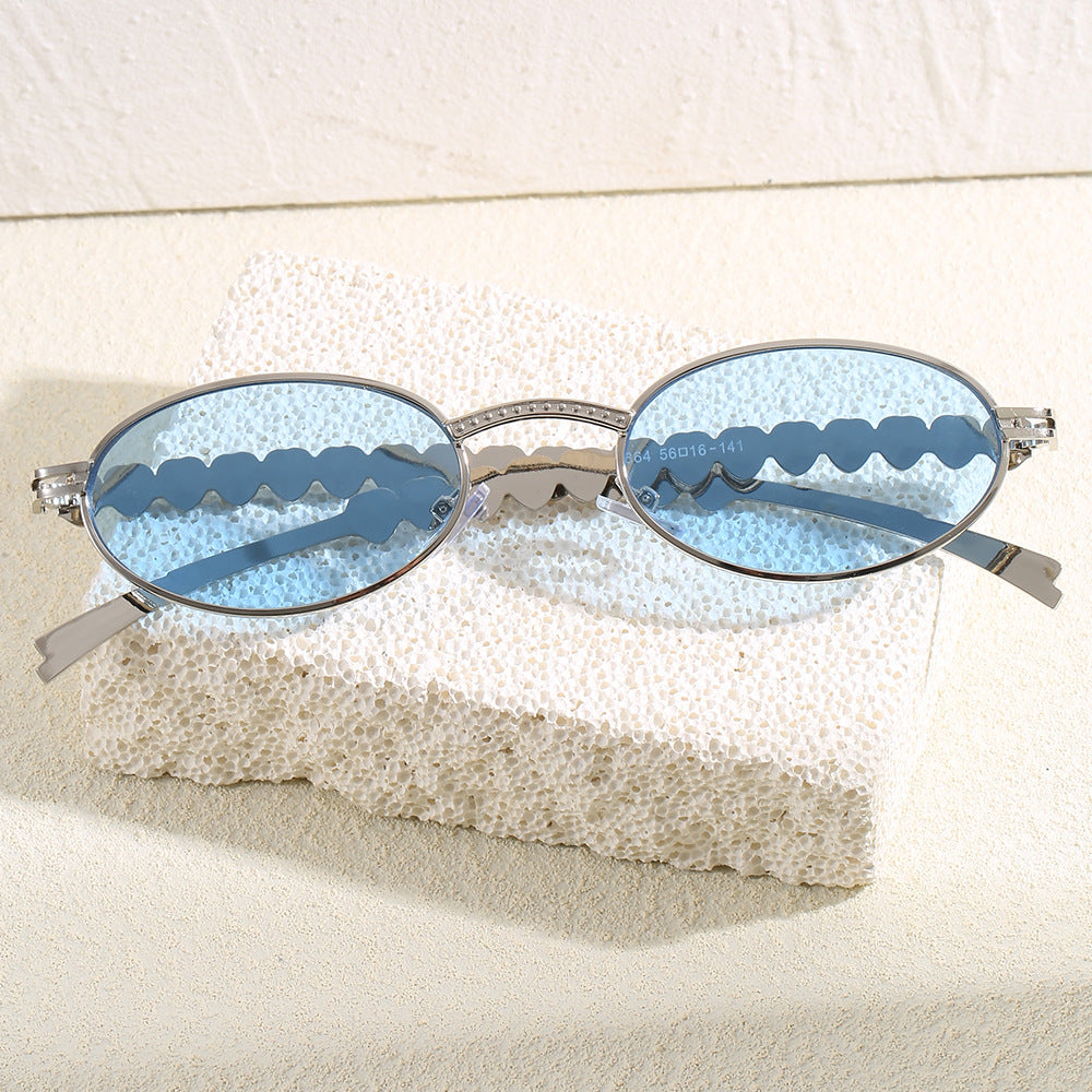 Women's oval frame sunglasses with luxurious gold accents, offering stylish UV protection for her summer look.