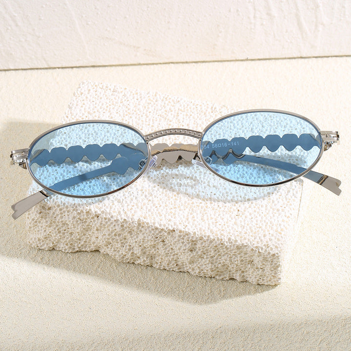 Women's oval frame sunglasses with luxurious gold accents, offering stylish UV protection for her summer look.