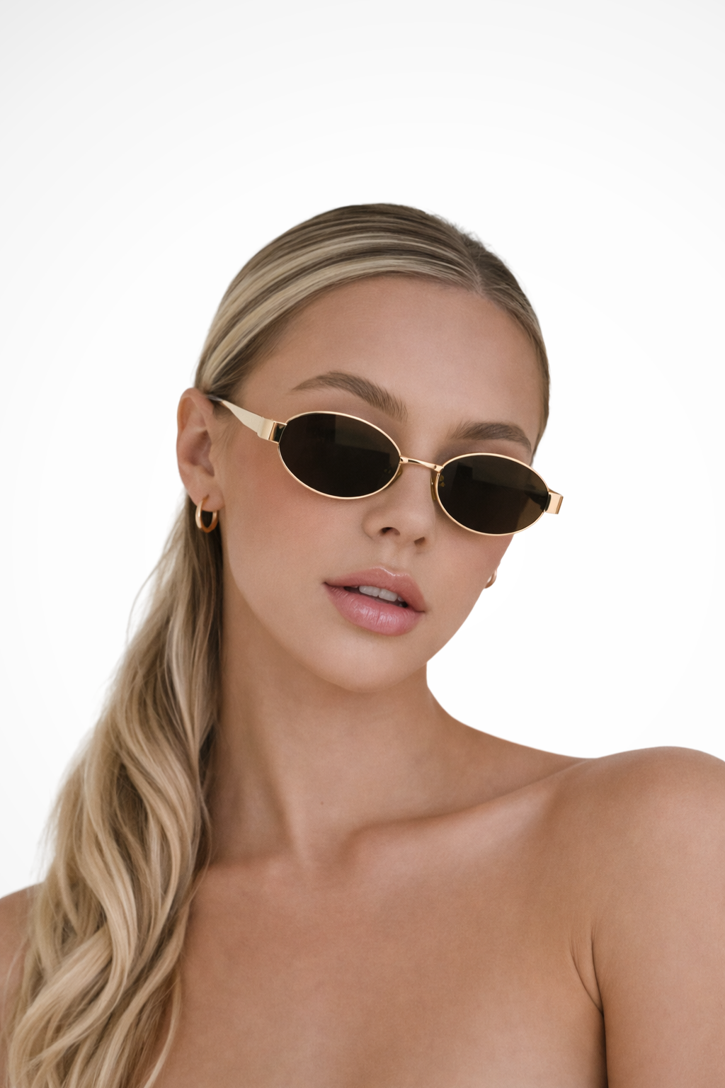 Lightweight metal frame oval women's sunglasses with dark tinted lenses for a trendy look.