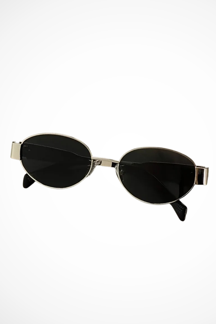 Elegant women's oval sunglasses with thin metal frames and tinted UV protective lenses.