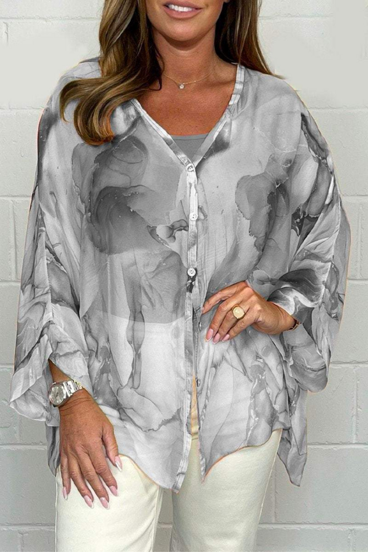 Elegant women's oversized blouse with a unique abstract print, long sleeve, button-down, versatile for fashion.