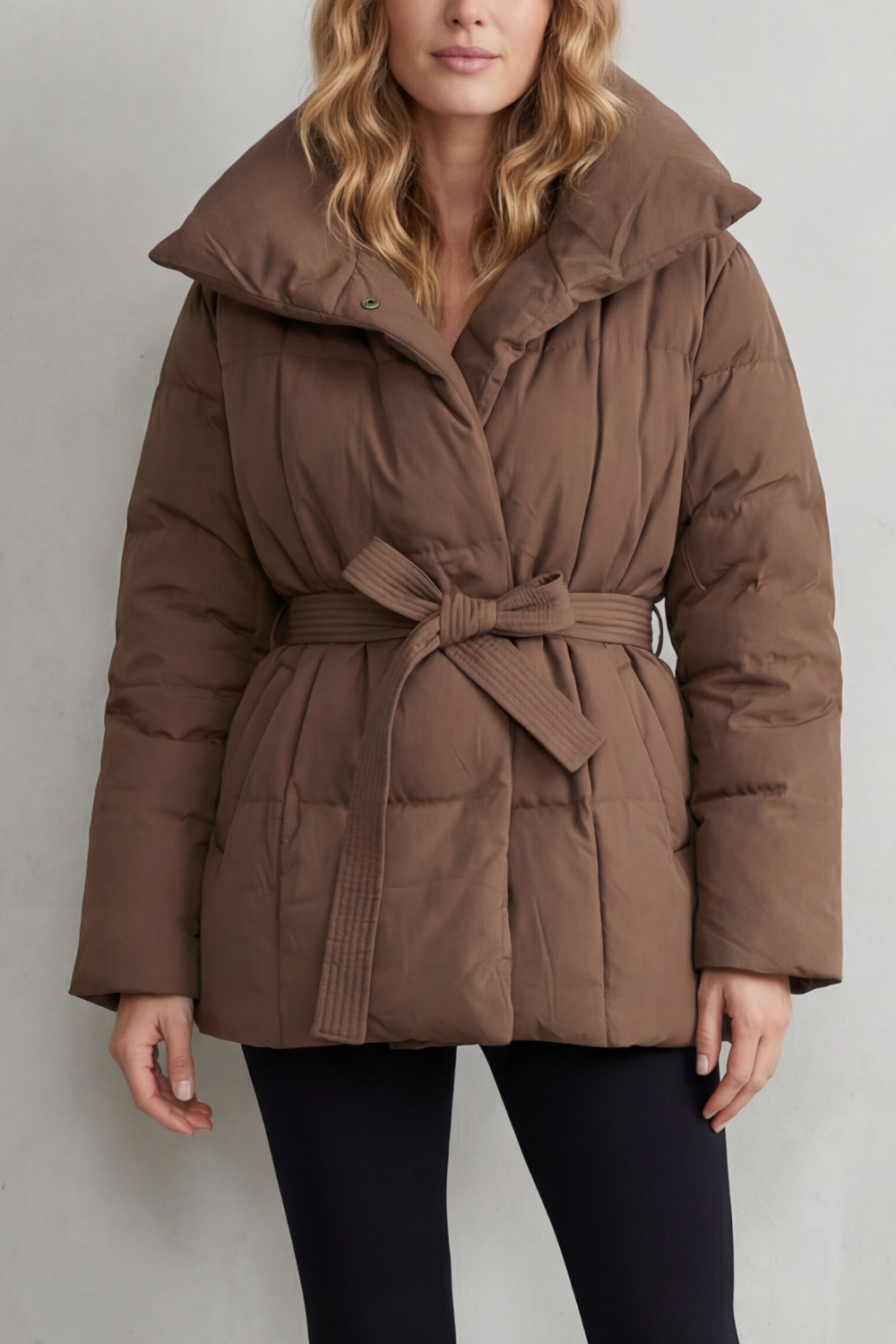 Women's oversized collar belted puffer coat, a warm winter essential for cold weather style.