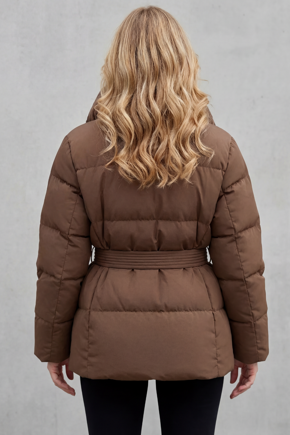 Cozy ladies' belted puffer jacket, offering warm outerwear & a stylish silhouette for cold weather.