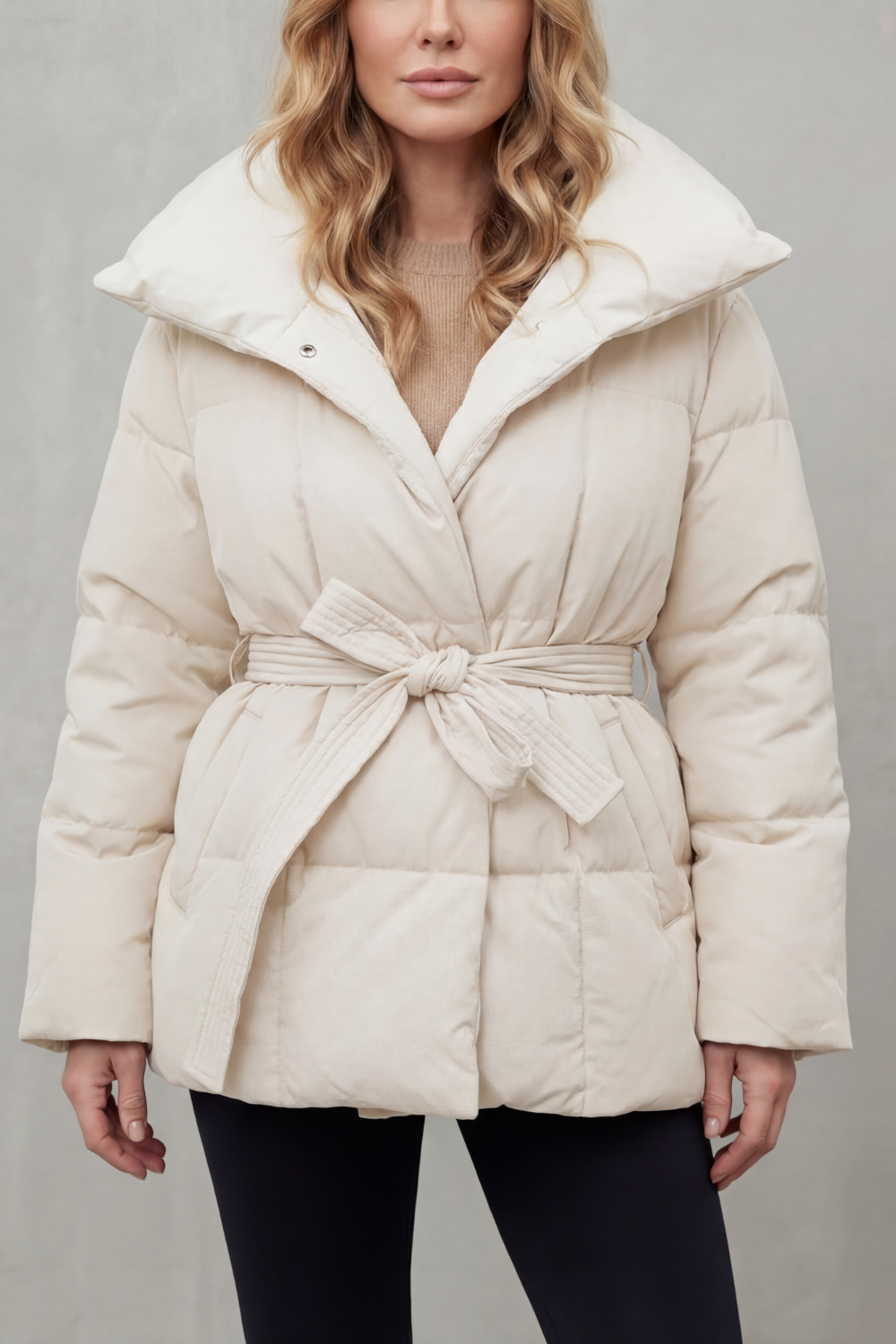 Stylish ladies' belted puffer jacket with cinched waist, perfect warm outerwear for a chic look.