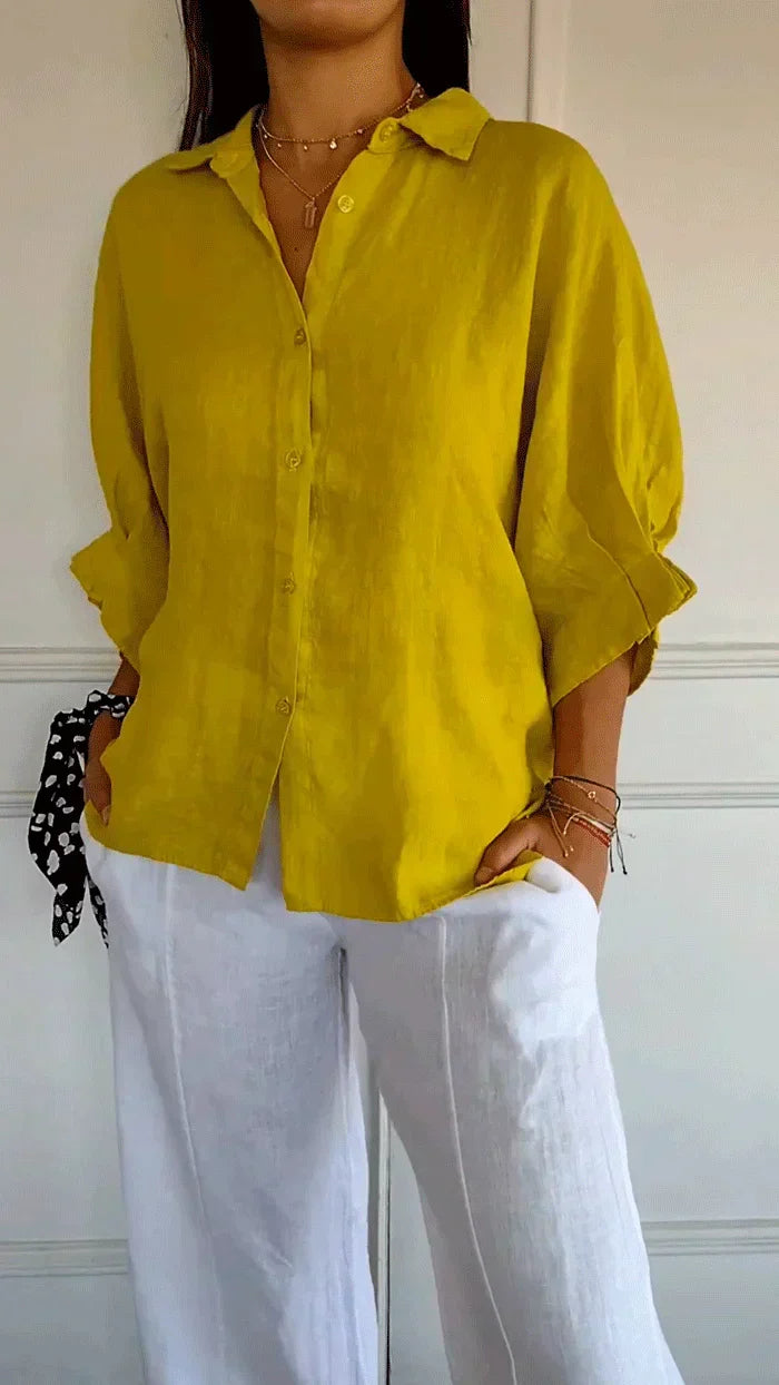 Fashionable women's oversized long sleeve collared shirt with button-front. A chic and versatile everyday top.