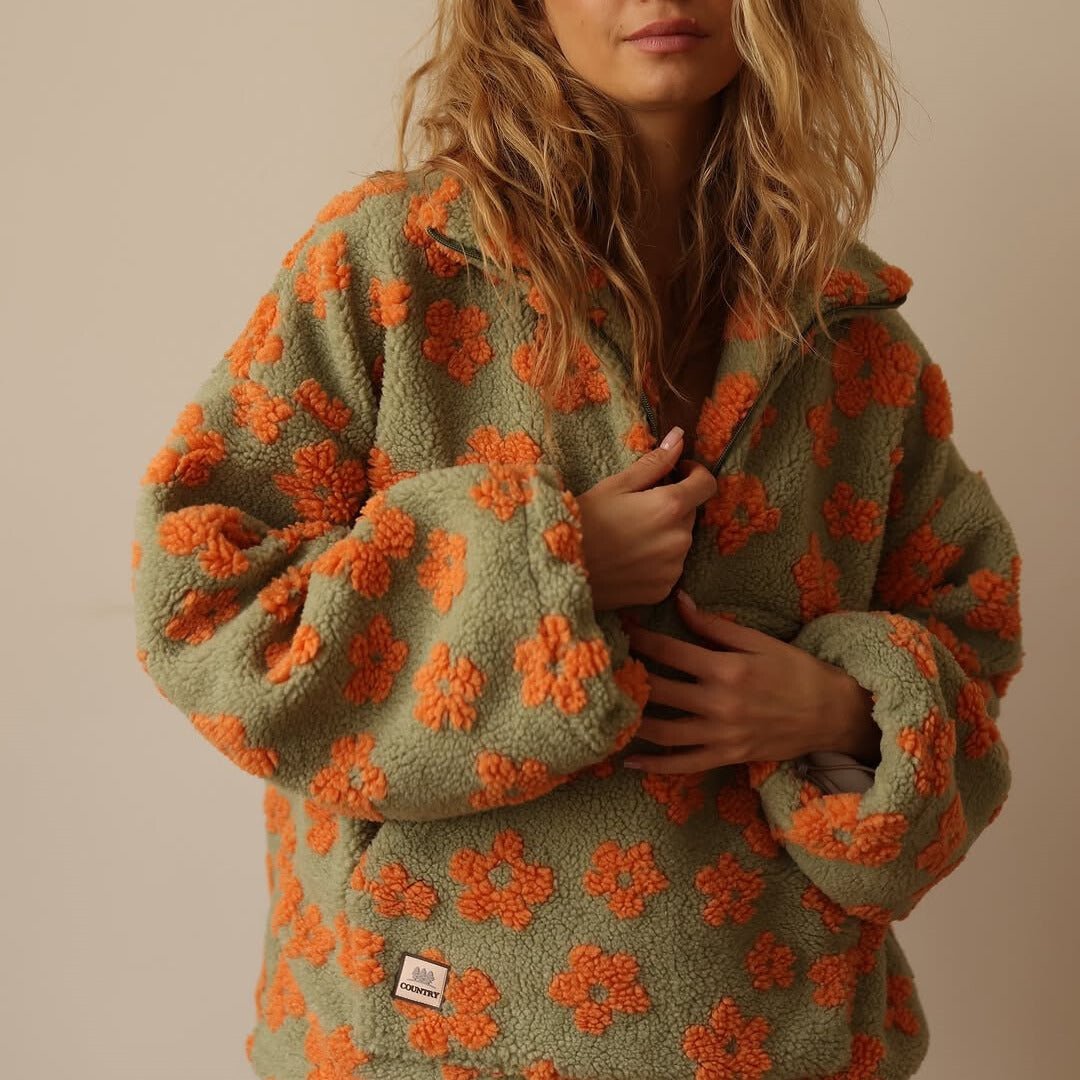 Front view of a women's oversized floral half-zip sweater jacket, perfect for fall and winter.