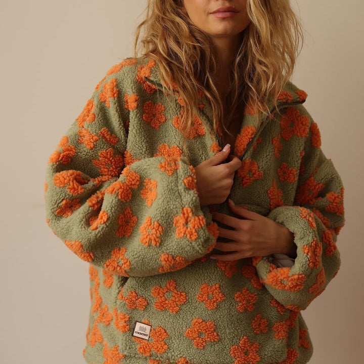 Front view of a women's oversized floral half-zip sweater jacket, perfect for fall and winter.