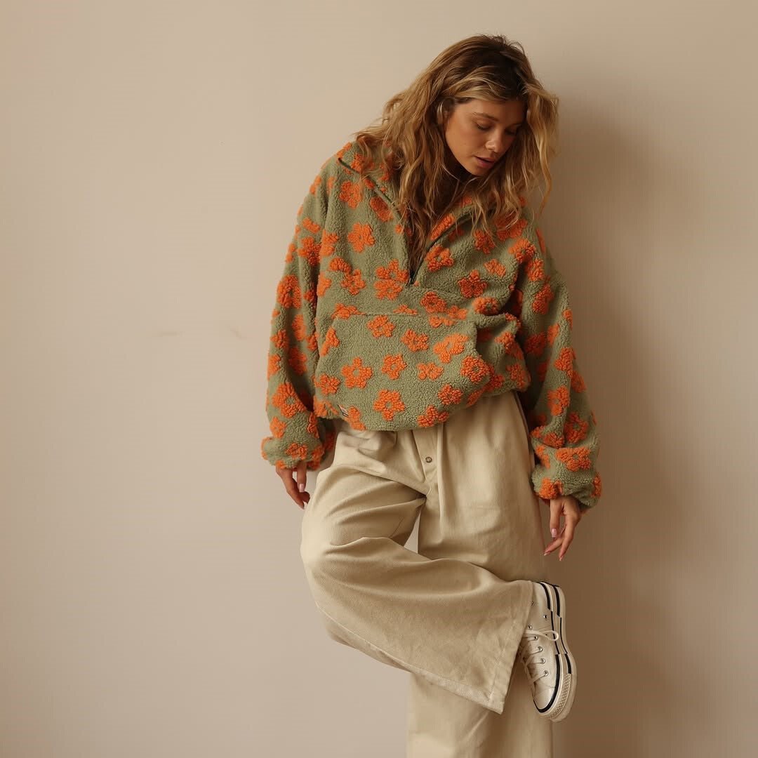 Women's half-zip oversized floral sweater jacket. Combines comfort and style for cold weather.