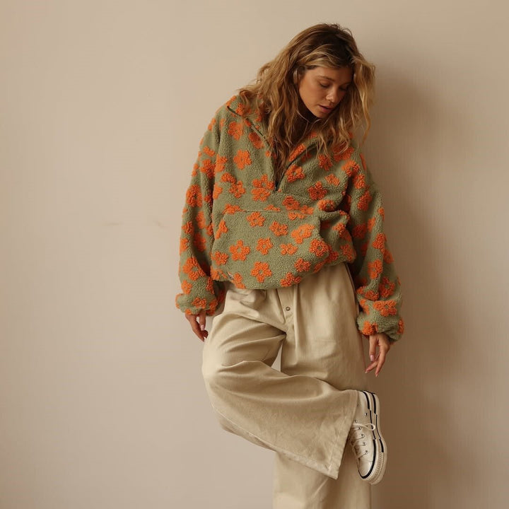 Women's half-zip oversized floral sweater jacket. Combines comfort and style for cold weather.